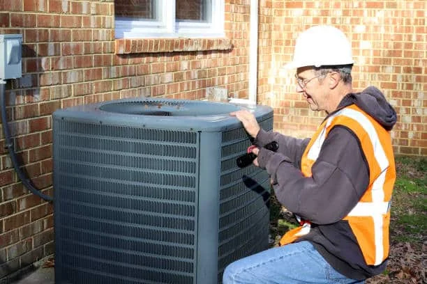 Professional technician inspecting a residential heating unit using specialized diagnostic tools
