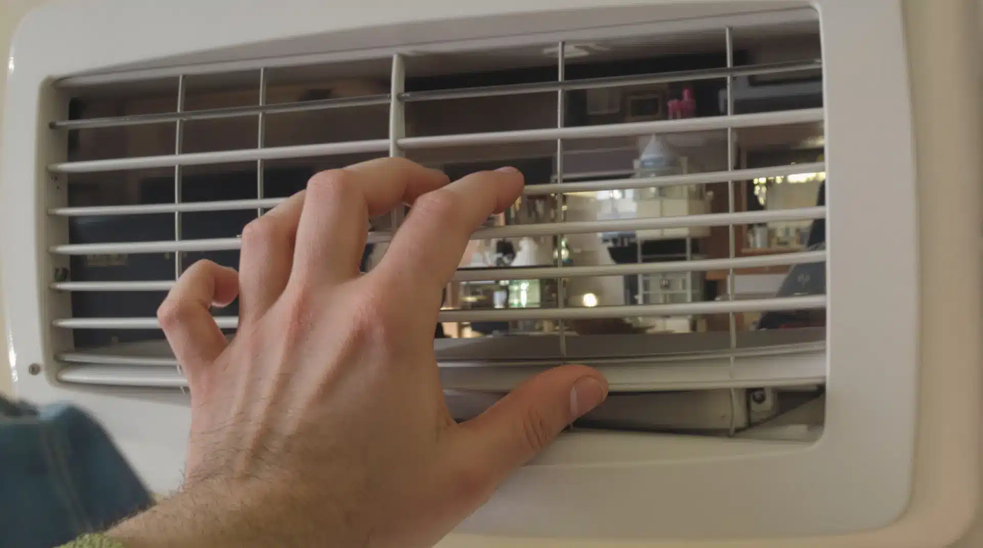 Image of hand in front of a vent for the blog, boiler vs furnace replacement Greeley
